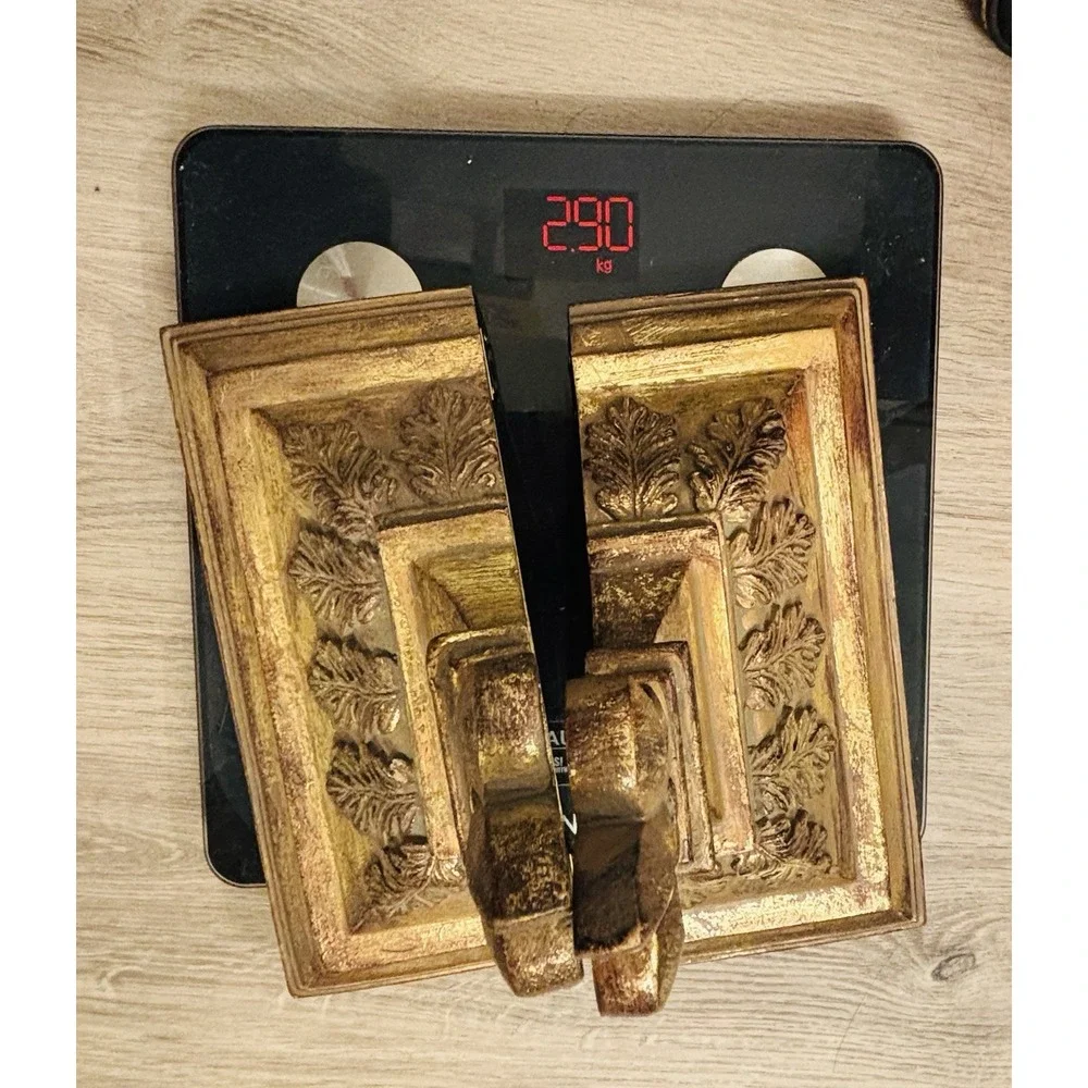 Vintage gold-toned decorative wall shelves with floral motifs.